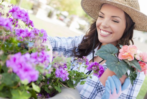 Gardener working on a suburban Sutton garden, trimming beds